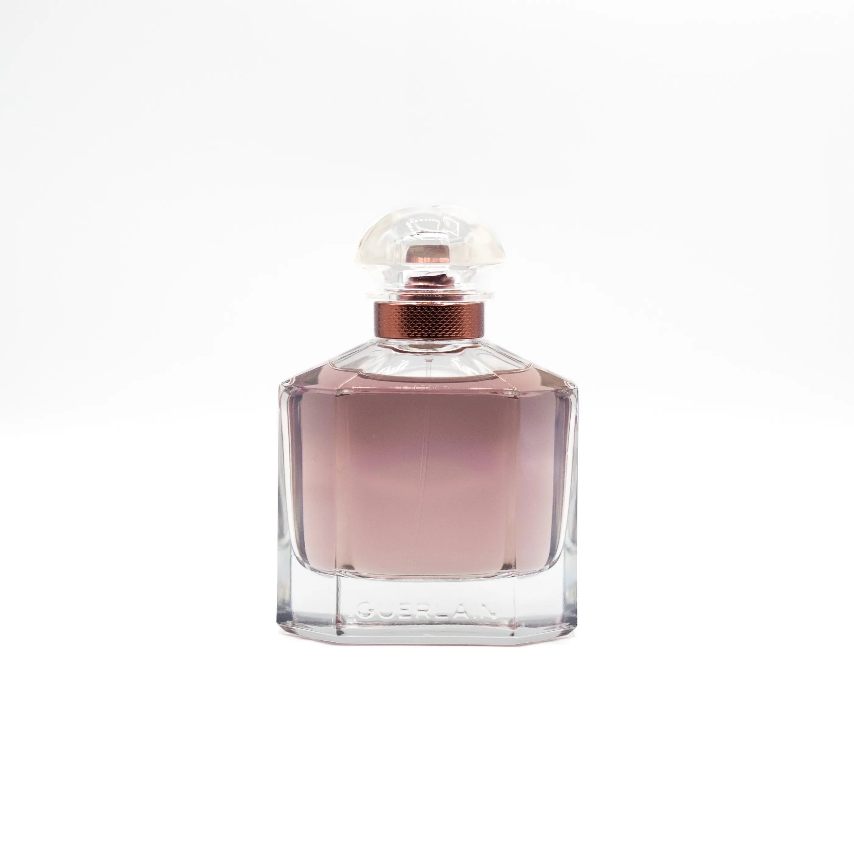 Perfume bottle with a pinkish liquid on a white background