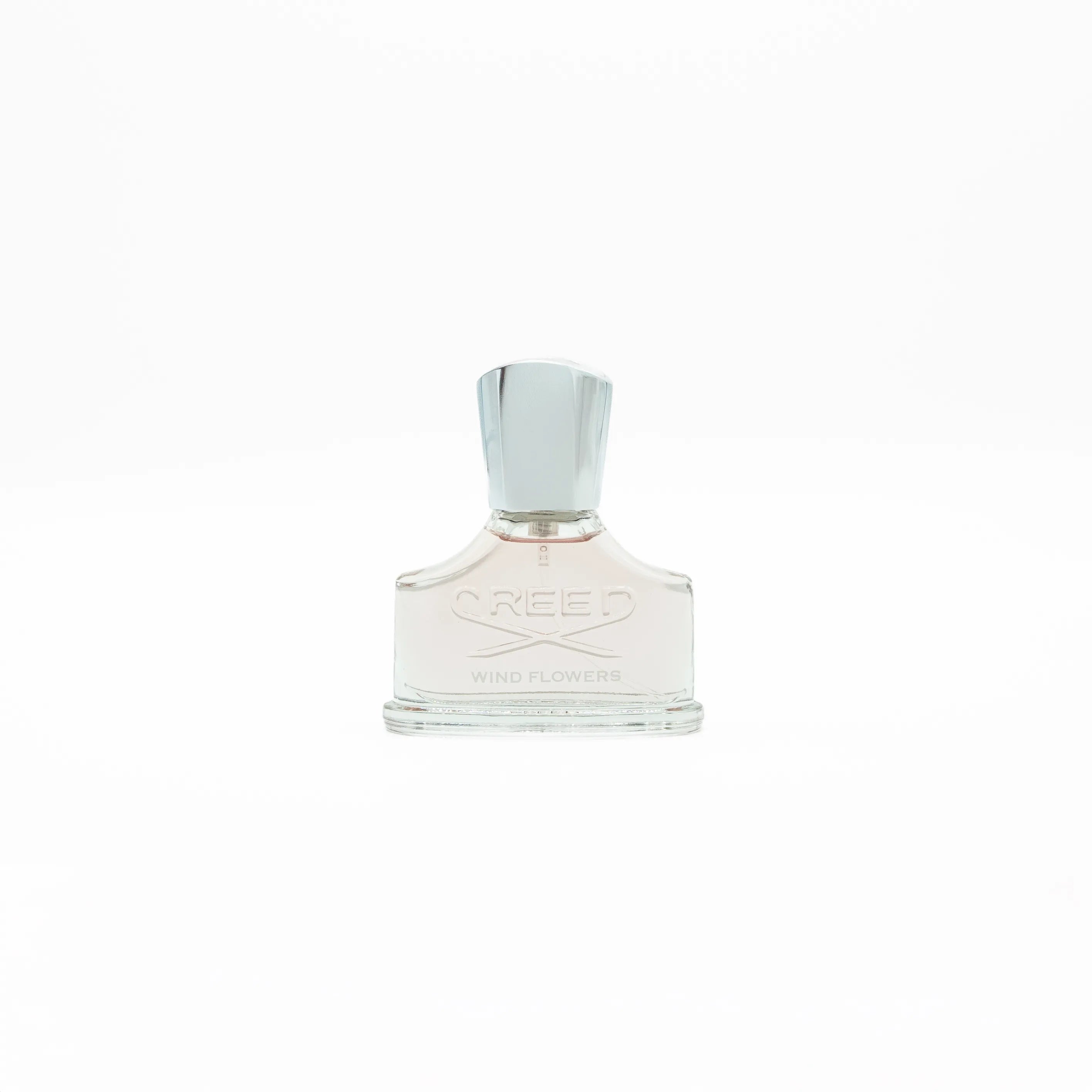 Perfume bottle with silver cap on a white background